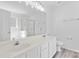 Bright bathroom features a double sink vanity, large mirror, and walk-in shower at 7212 Ravanna Dr, Charlotte, NC 28213