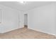 This bedroom has neutral carpeting and a door to the closet or bathroom at 7212 Ravanna Dr, Charlotte, NC 28213