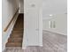 Bright entryway showcases a staircase, modern gray flooring, and a glimpse into the living space at 7212 Ravanna Dr, Charlotte, NC 28213