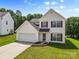 Charming two-story home featuring a well-maintained lawn, attached garage, and inviting curb appeal at 7212 Ravanna Dr, Charlotte, NC 28213