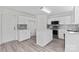 Bright kitchen with white cabinets, island, stainless steel appliances, and grey backsplash at 7212 Ravanna Dr, Charlotte, NC 28213