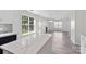 Open-concept living room and kitchen featuring stone countertops and plenty of natural light at 7212 Ravanna Dr, Charlotte, NC 28213