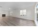Bright living room features a fireplace, neutral paint, and lots of light from a large window at 7212 Ravanna Dr, Charlotte, NC 28213