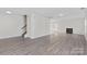 Spacious living room with hardwood floors, neutral walls, a fireplace and staircase at 7212 Ravanna Dr, Charlotte, NC 28213