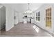 Living room and kitchen featuring wood-look floors and natural light from surrounding windows at 7212 Ravanna Dr, Charlotte, NC 28213
