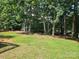 Well maintained backyard with mature trees providing shade and privacy at 7691 Red Robin Trl, Denver, NC 28037