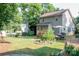 A lush backyard with a deck, patio furniture, and ample space for outdoor activities at 7691 Red Robin Trl, Denver, NC 28037