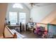 Sunlit loft space with vaulted ceilings, ceiling fan and hardwood floors, ideal for a home office at 7691 Red Robin Trl, Denver, NC 28037