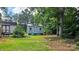 Charming shed in a backyard with a well maintained lawn surrounded by mature trees at 7691 Red Robin Trl, Denver, NC 28037