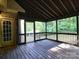 Spacious screened-in back porch with wood floor and natural views, perfect for relaxing or entertaining at 9913 Hazelview Dr, Charlotte, NC 28277
