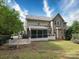 A spacious backyard featuring a screened-in porch, lush lawn and access to a gated area at 9913 Hazelview Dr, Charlotte, NC 28277