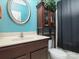 This bathroom features a decorative cabinet, white toilet, and round mirror at 9913 Hazelview Dr, Charlotte, NC 28277