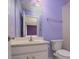 Bathroom featuring single vanity, toilet, shower/tub combination and lavender colored walls at 9913 Hazelview Dr, Charlotte, NC 28277