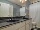 Modern bathroom with double vanity featuring black countertops, providing a sleek design at 9913 Hazelview Dr, Charlotte, NC 28277