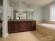Bright bathroom featuring a double vanity, and a soaking tub for ultimate relaxation and comfort at 9913 Hazelview Dr, Charlotte, NC 28277