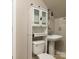 Bathroom with pedestal sink, white toilet, and glass fronted cabinet at 9913 Hazelview Dr, Charlotte, NC 28277