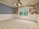Spacious bedroom with large window, ceiling fan and wainscoting, offering natural light and comfort at 9913 Hazelview Dr, Charlotte, NC 28277