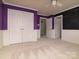 Bedroom featuring unique blackboard wall, closet, wainscoting, and a ceiling fan for comfort at 9913 Hazelview Dr, Charlotte, NC 28277