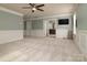 Expansive bonus room with wainscoting, ceiling fan and access to another room at 9913 Hazelview Dr, Charlotte, NC 28277
