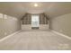 Attic bonus room with built-in storage and natural light, offering a versatile living space at 9913 Hazelview Dr, Charlotte, NC 28277