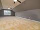 Large bonus room with dormered ceiling and three ceiling fans offering versatile space for any need at 9913 Hazelview Dr, Charlotte, NC 28277