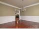 Elegant dining room with hardwood floors, chair rail detail and a chandelier at 9913 Hazelview Dr, Charlotte, NC 28277