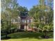 Charming two-story brick home with mature trees and a well-manicured lawn in a desirable neighborhood at 9913 Hazelview Dr, Charlotte, NC 28277