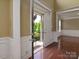 Inviting foyer with polished hardwood floors, decorative wainscoting, and a view of the landscaped front yard at 9913 Hazelview Dr, Charlotte, NC 28277