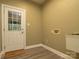 Functional laundry room with white door, cabinet, and neutral walls at 9913 Hazelview Dr, Charlotte, NC 28277