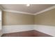 Cozy living room features large window, chair rail detail and wood flooring at 9913 Hazelview Dr, Charlotte, NC 28277