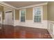 Spacious living area featuring gleaming hardwood floors, and large windows that provide natural light at 9913 Hazelview Dr, Charlotte, NC 28277