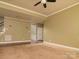 This living room is open and inviting, with hardwood floors visible under neutral carpet at 9913 Hazelview Dr, Charlotte, NC 28277