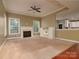 Spacious living room featuring a fireplace, ceiling fan, and built-in shelving at 9913 Hazelview Dr, Charlotte, NC 28277