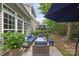 Inviting back patio with outdoor seating, string lights, and lush landscaping at 10206 Linksland Dr, Huntersville, NC 28078