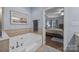 Bright bathroom with a soaking tub and a view of the bedroom at 10206 Linksland Dr, Huntersville, NC 28078