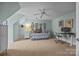 Bedroom featuring a daybed, work space, ceiling fan, and ample wall art at 10206 Linksland Dr, Huntersville, NC 28078