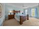 Bedroom features a queen-size bed, wood furniture, and bright windows at 10206 Linksland Dr, Huntersville, NC 28078
