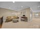 Loft area featuring a comfy sofa, ceiling fan, and writing desk at 10206 Linksland Dr, Huntersville, NC 28078