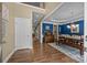 Open-concept dining room with hardwood floors, blue accent wall and coffered ceilings at 10206 Linksland Dr, Huntersville, NC 28078