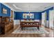 A dining room highlighted by bold blue walls, a patterned rug and classic decor at 10206 Linksland Dr, Huntersville, NC 28078