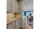 Butlers pantry offers a view into the dining room featuring bright blue accent wall at 10206 Linksland Dr, Huntersville, NC 28078