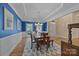 A dining room highlighted by bold blue walls, a patterned rug and classic decor at 10206 Linksland Dr, Huntersville, NC 28078