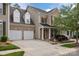 Charming brick townhome with a well-manicured lawn and attached two-car garage at 10206 Linksland Dr, Huntersville, NC 28078