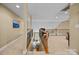 Hallway overlooking the living room with black wrought iron staircase at 10206 Linksland Dr, Huntersville, NC 28078
