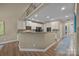 Kitchen with granite countertops, white cabinets, stainless steel appliances and an open floor plan at 10206 Linksland Dr, Huntersville, NC 28078