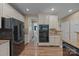 Modern kitchen featuring stainless steel appliances, granite countertops, and white cabinets at 10206 Linksland Dr, Huntersville, NC 28078