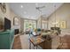 Open-concept living area with a fireplace and large windows overlooking the backyard at 10206 Linksland Dr, Huntersville, NC 28078