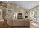 Bright living room with fireplace, tv, large couch and view of the staircase and balcony at 10206 Linksland Dr, Huntersville, NC 28078