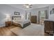 Spacious main bedroom with wood floors, soft colors and a ceiling fan at 10206 Linksland Dr, Huntersville, NC 28078