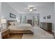 Comfortable main bedroom with wood floors, soft colors and a ceiling fan at 10206 Linksland Dr, Huntersville, NC 28078